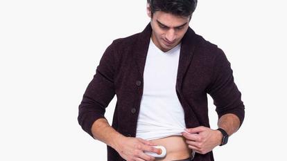 Man applying Dexcom sensor to his stomach